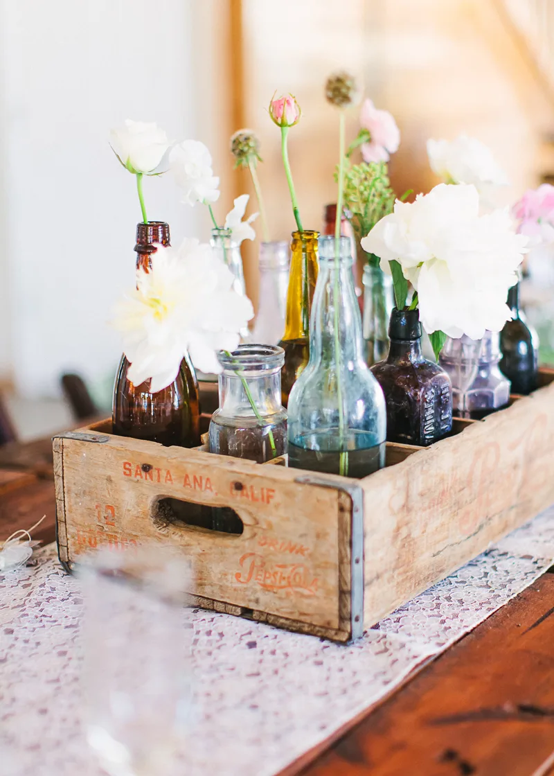 Reception Table with old wood box and flowers in bottles